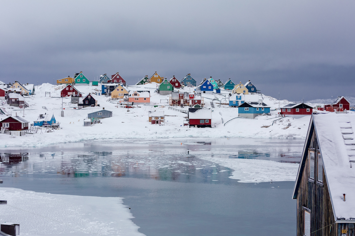 Colorful houses by the frozen fjord in Aasiaat