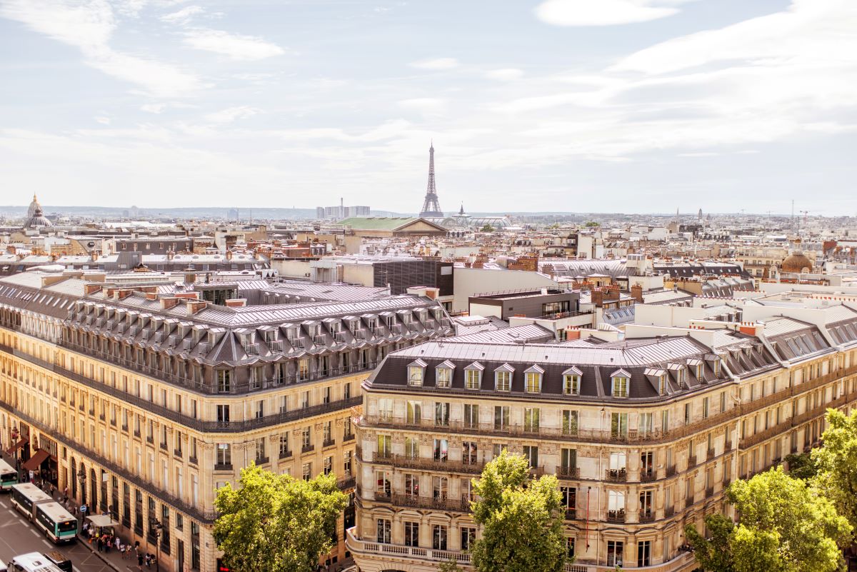 The Eiffel Tower rises among the city’s buildings